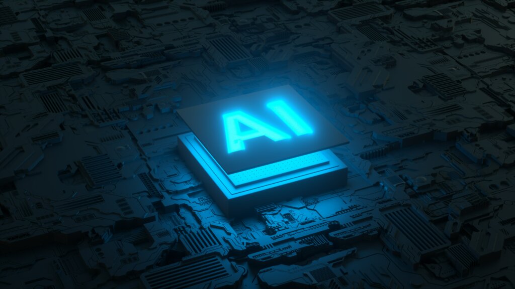 Imagem referente ao conteúdo "Testes de software com IA", com uma placa de circuito e microprocessador AI, abreviação de artificial intelligence (inteligência artificial em inglês).