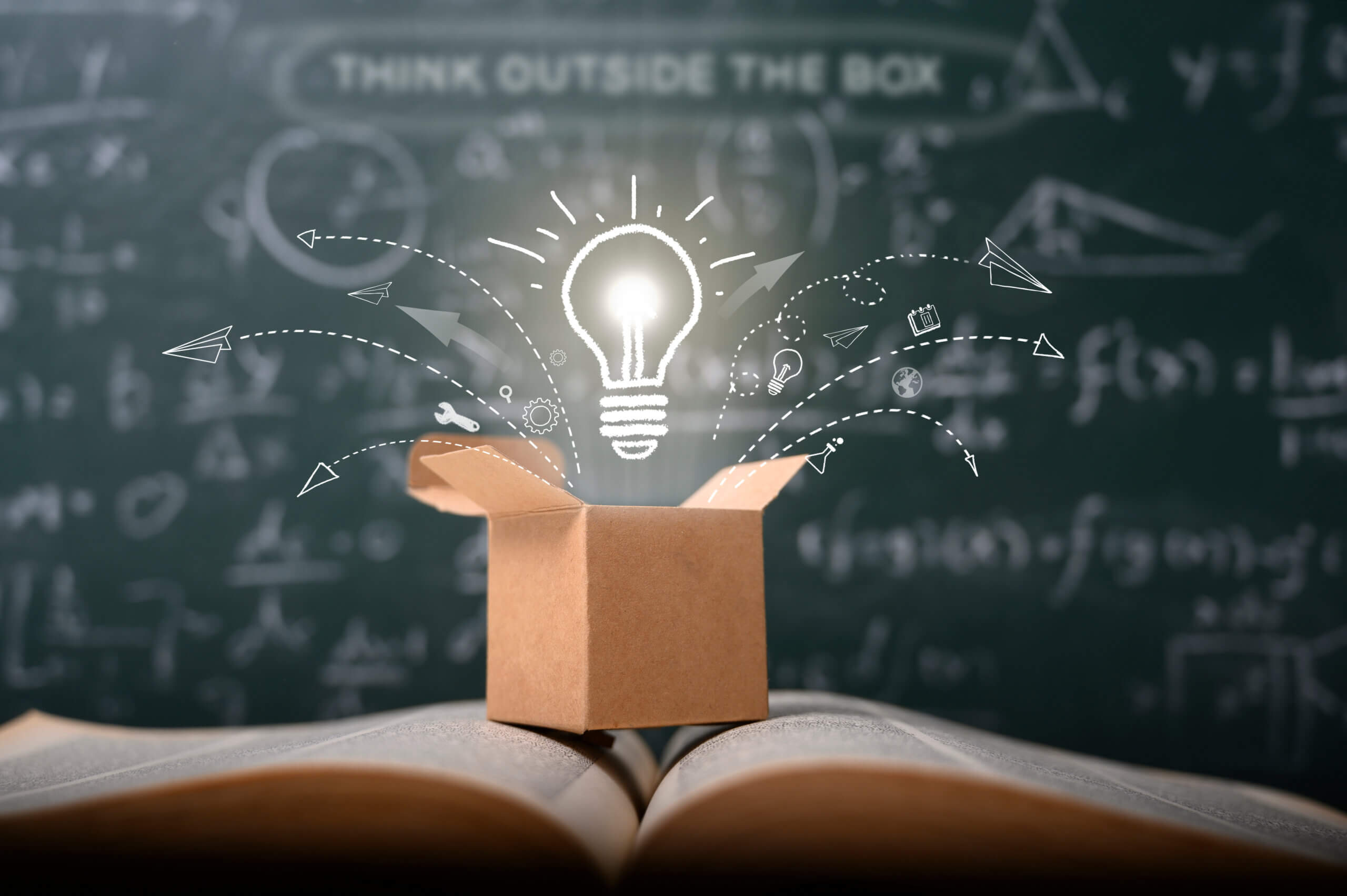 A imagem corresponde ao conteúdo "Curva de adoção da inovação : os desafios de criar um novo produto", onde passa uma ideia de pense fora da caixa na lousa verde da escola. conceito de educação de inicialização. ideia criativa.